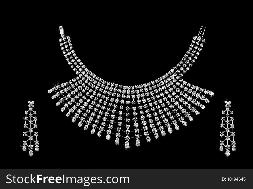 Diamond necklace on dark black background with ear rings