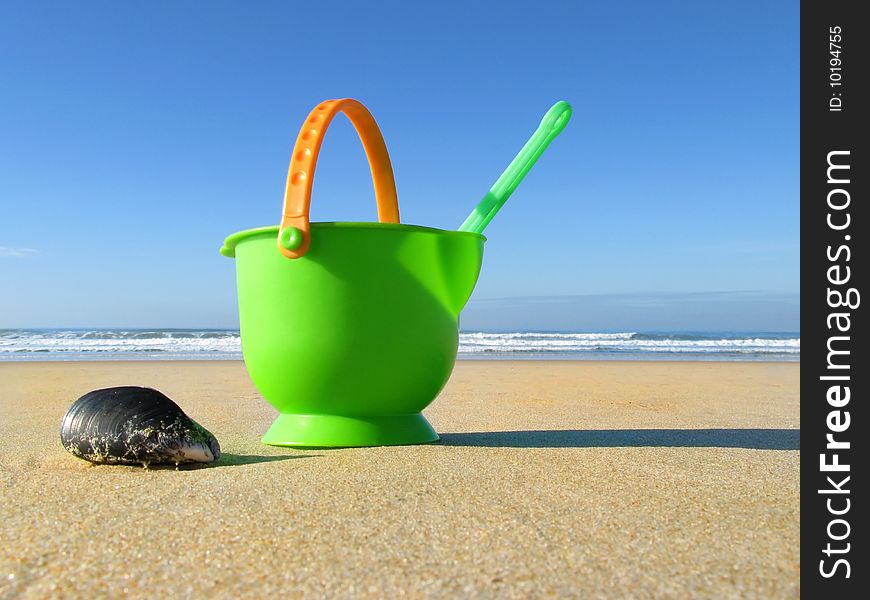 Bucket and spade on tropical beach with blue sky. Bucket and spade on tropical beach with blue sky