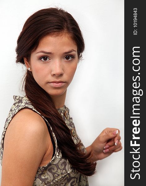 Portrait of young charming girl in dress on a white background