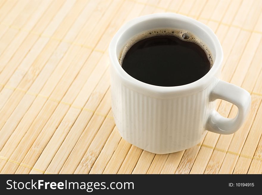 Coffee Cup On A Bamboo Mat.