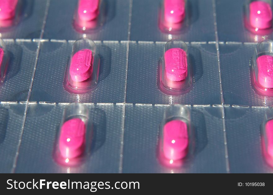 Details of pink medicinal pills in blister pack. Details of pink medicinal pills in blister pack.