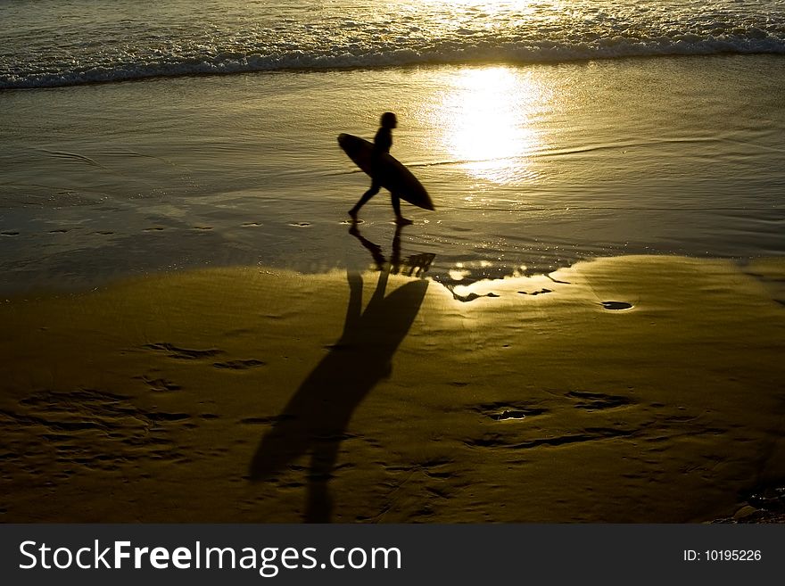 Silhouette of a male surfer at sunrise on the gold coast. Silhouette of a male surfer at sunrise on the gold coast