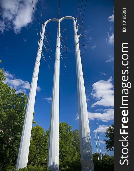 White power pole against blue sky with clouds