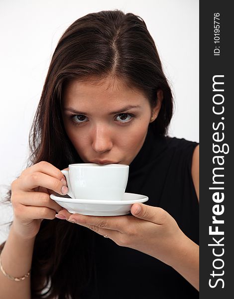 Portrait of young charming girl with a cup of coffee on a white background