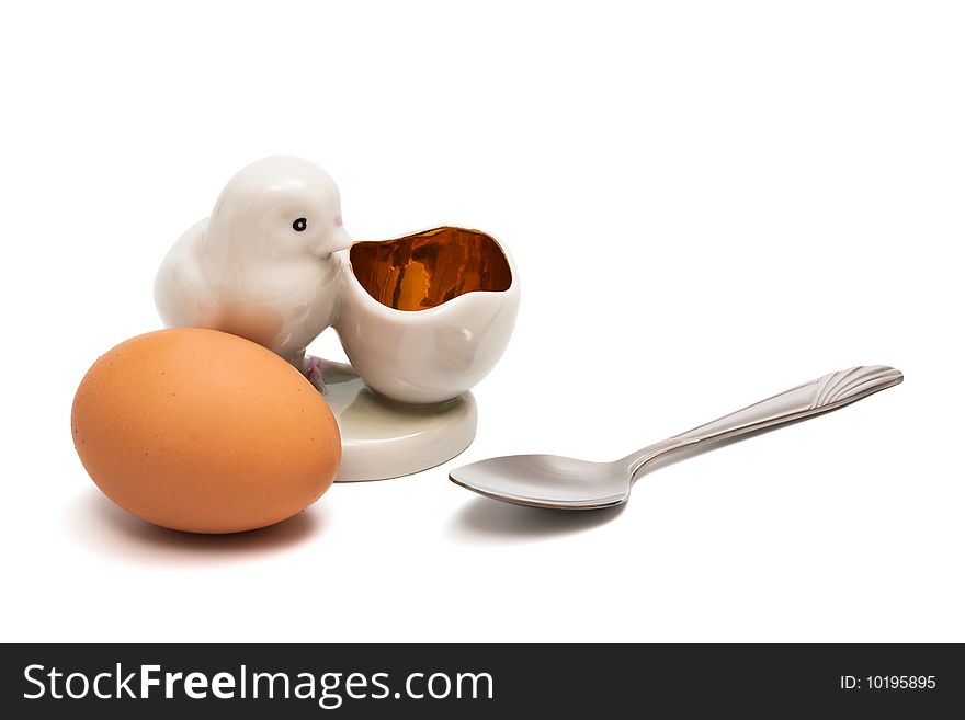 Egg and the spoon on a white background