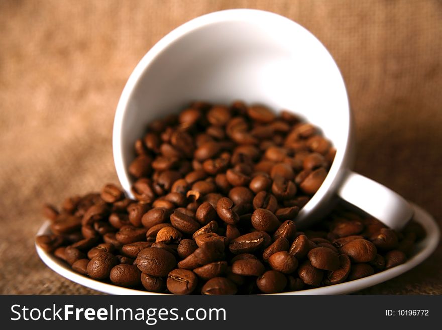 Cup, dish and beans of coffee. Cup, dish and beans of coffee