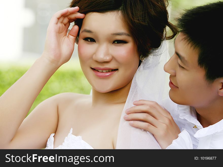 Young chinese couple in wedding dress