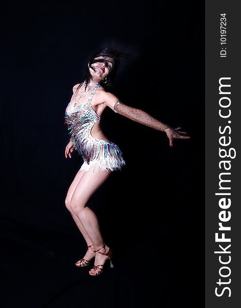 Dancer in action against black background