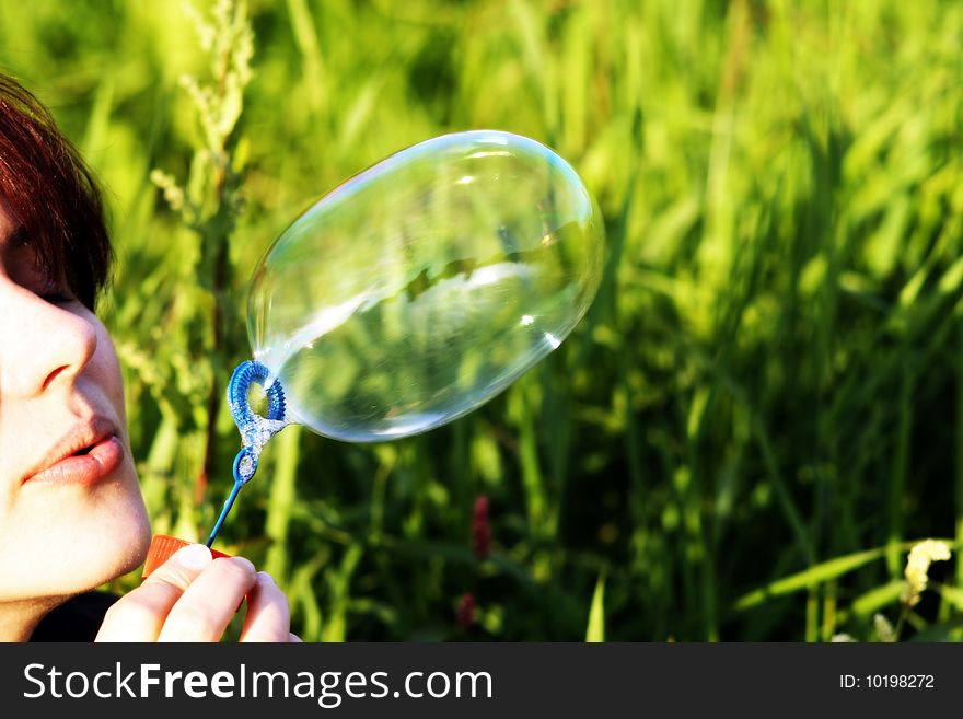 A Woman Is Blowing A  Bubble