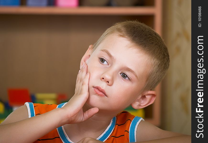 The boy of 7 years is engaged in a children's room