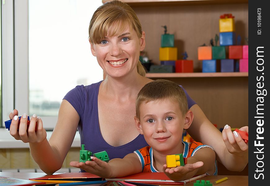The mum with son is engaged in a children's room. The mum with son is engaged in a children's room