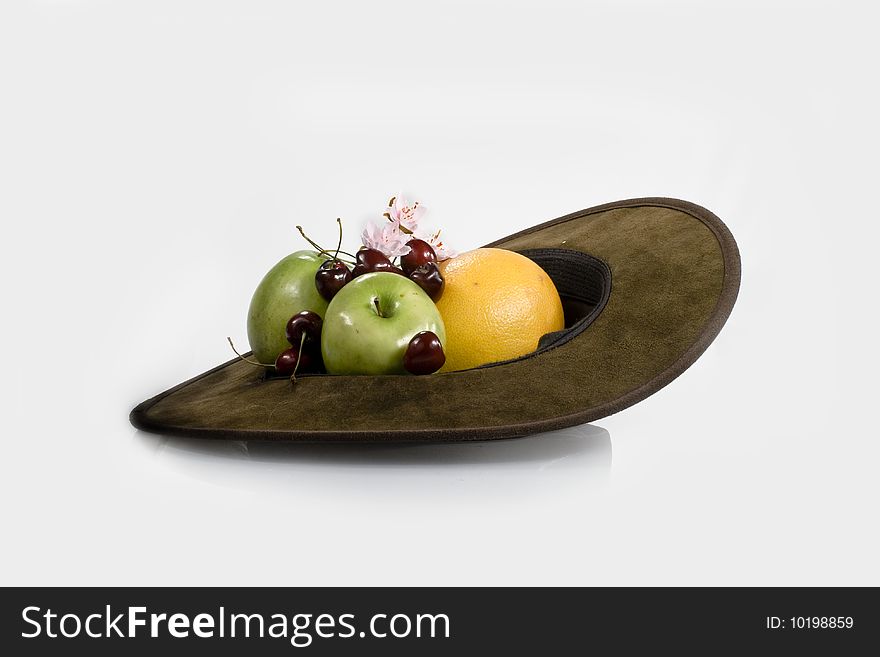 Set of fruit from apples of an orange and cherries in a hat. Set of fruit from apples of an orange and cherries in a hat