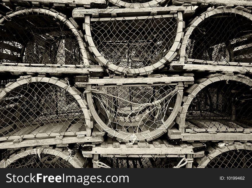 An image of old lobster traps resting by the sea.