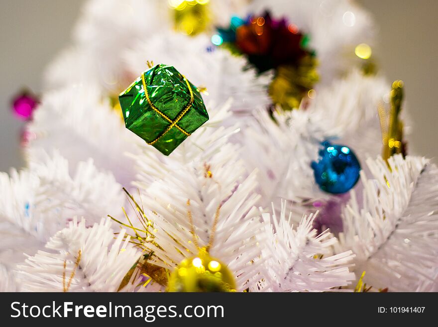 Festive pine white - Christmas decorative with gift box on Christmas tree