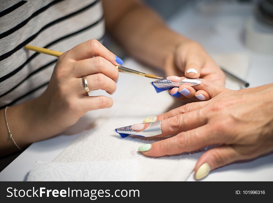 Manicure. Master Make Nail Extension. Hands Closeup.