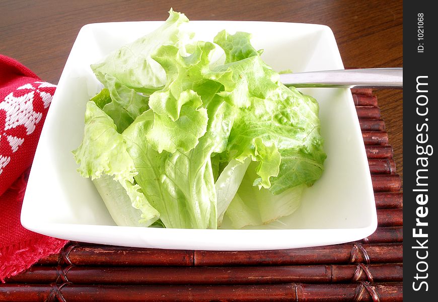 Salad of lettuce in a square chinaware