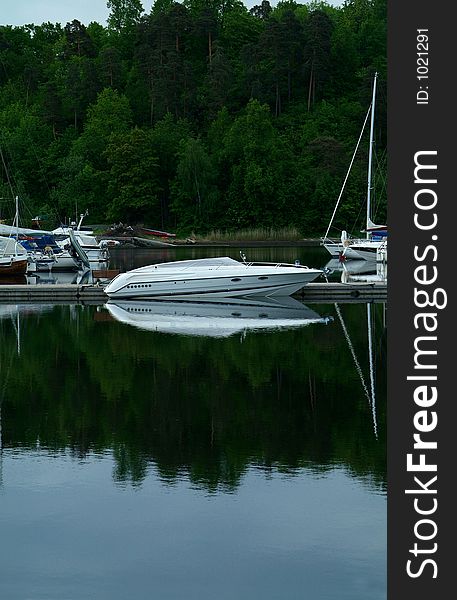 White speedboat at a pier