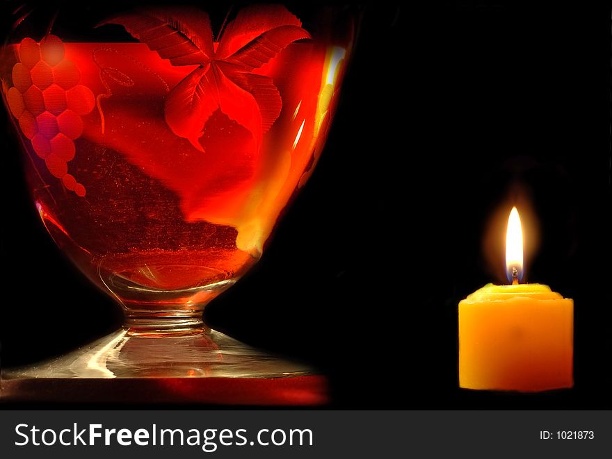 Carafe and candle on black background. Carafe and candle on black background