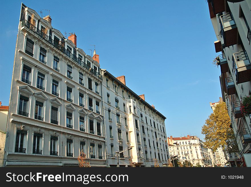 19th century facade in Lyon (France). Notice the contrast between the old facades (on the left of the street) and the moder one on the other side. 19th century facade in Lyon (France). Notice the contrast between the old facades (on the left of the street) and the moder one on the other side.