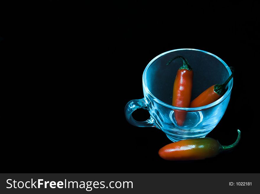 Chillies with a glass cup. Chillies with a glass cup