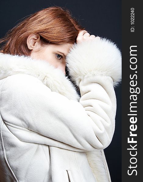 Woman with fur coat on black background. Woman with fur coat on black background