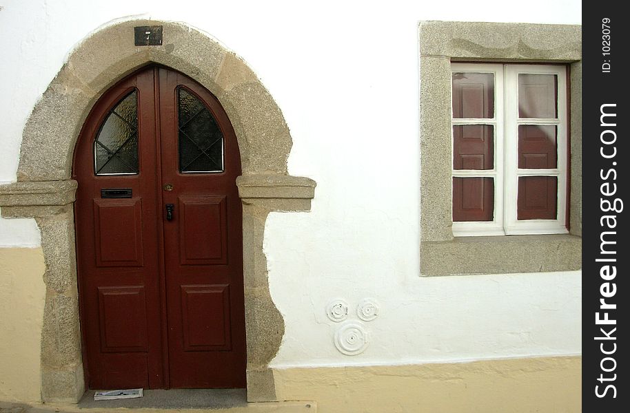 Door in ogive in a typical street of the city of Évora, which is considered património of the humanity for UNESCO. Door in ogive in a typical street of the city of Évora, which is considered património of the humanity for UNESCO.