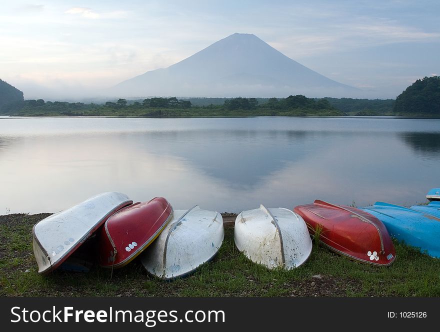 Colorful rowboats on the lakeshore, with Mount Fuji in the background