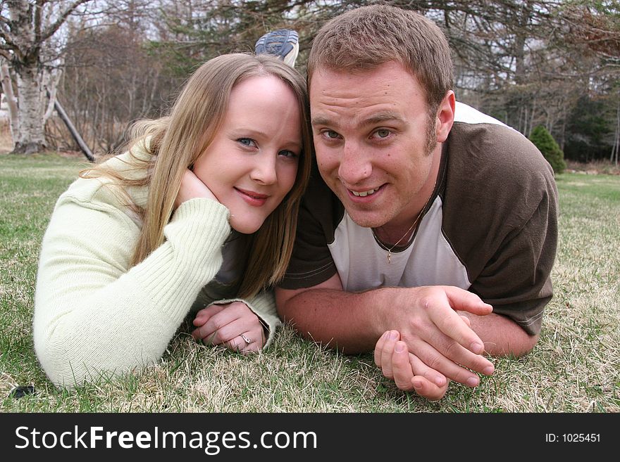 Young couple lying in grass. Young couple lying in grass