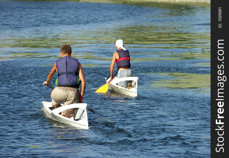 Two young boy in kayaks. Two young boy in kayaks