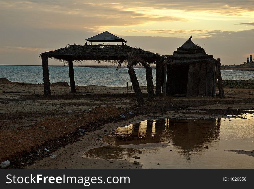 Pool and bar silhouetted against sunset. Pool and bar silhouetted against sunset