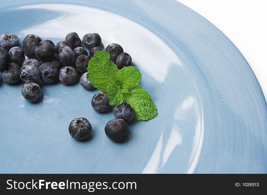 Blueberries on blue plate. Blueberries on blue plate
