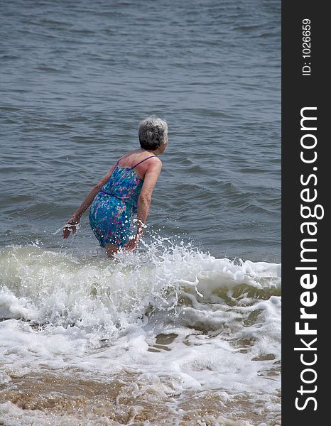Mature woman enjoying the summer surf. Mature woman enjoying the summer surf