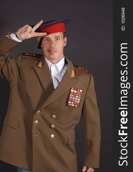 Portrait of a man dressed in a military uniform, with a humorous expression on his face. Portrait of a man dressed in a military uniform, with a humorous expression on his face