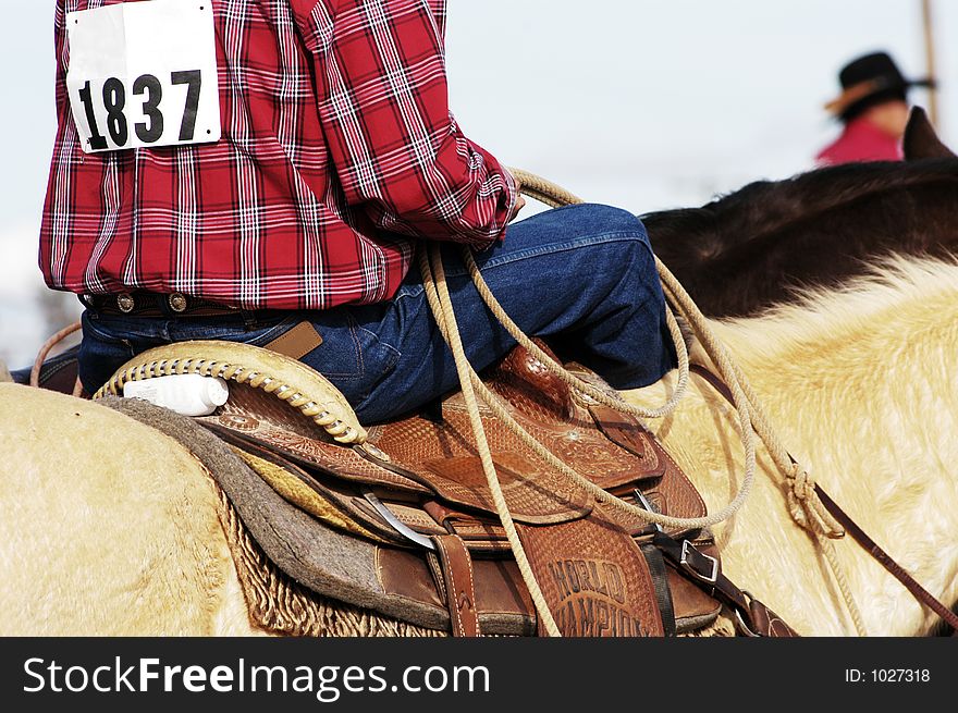 A cowboy waits to compete in the roping competition. A cowboy waits to compete in the roping competition.