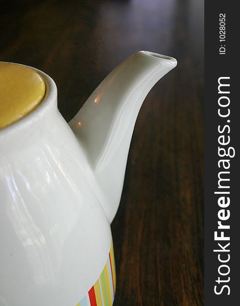 A teapot on a table. A teapot on a table