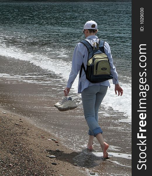 Girl walking alone on a beach