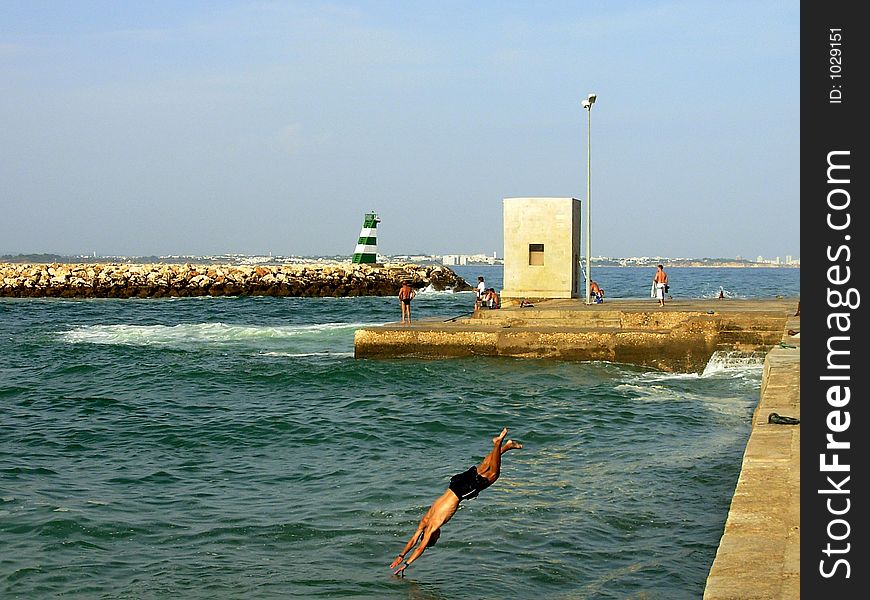 Jump for the water in Batata beach, Lagos, Portugal. Jump for the water in Batata beach, Lagos, Portugal.