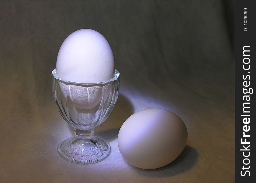 Eggs and the egg cup are the theme for breakfast.  Used lighting from flashlights to create this effect. Eggs and the egg cup are the theme for breakfast.  Used lighting from flashlights to create this effect.