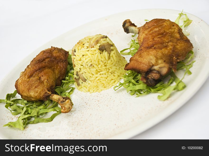 Chicken legs with rice garnish