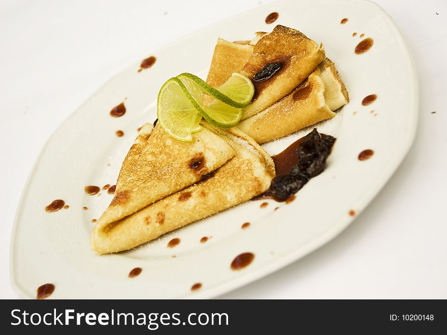 Pancakes with jam on a plate decorated with lime,see more in <a href=http://www.dreamstime.com/restaurant-food-rcollection10721-resi828293>Restaurant food</a>