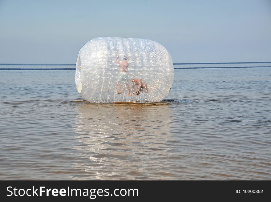 Attractsion the inflatable cylinder on a beach at coast in JÃ¼rmala (Latvia)