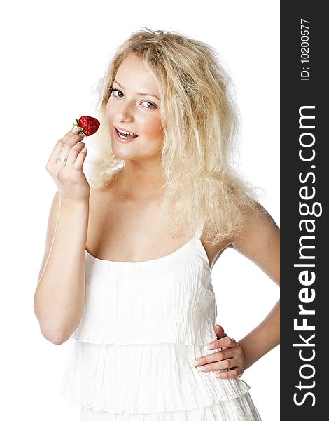 Young woman in white dress eating strawberries. Isolated on white background