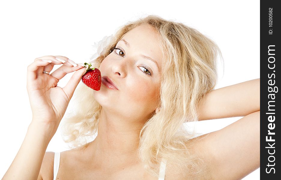 Young woman in white dress eating strawberries