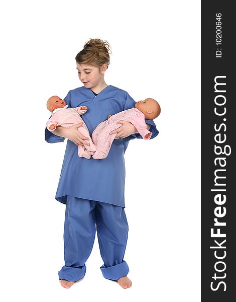 Little girl in medical scrubs holding two infant dolls. Little girl in medical scrubs holding two infant dolls