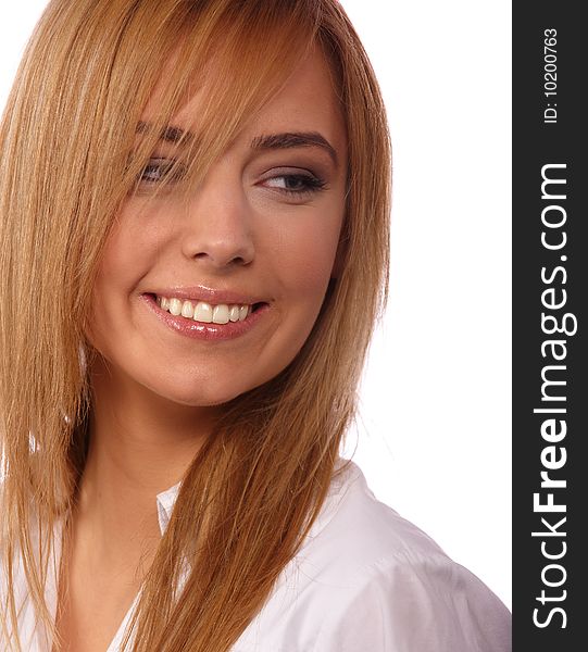 Portrait of a young beautiful smiling blonde in a white blouse on a light background. Portrait of a young beautiful smiling blonde in a white blouse on a light background