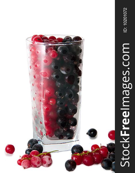 Mix with frozen red and black currants in a glass on white