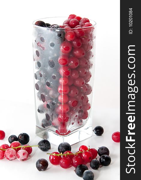 Mix with frozen red and black currants in a glass on white