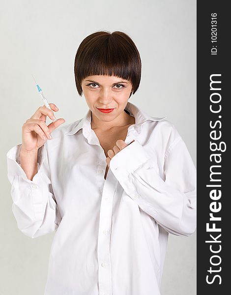 Portrait of a beautiful young girl nurse with syringe