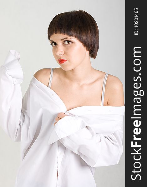 Young Girl Stands In A Shirt With A Raised Hand