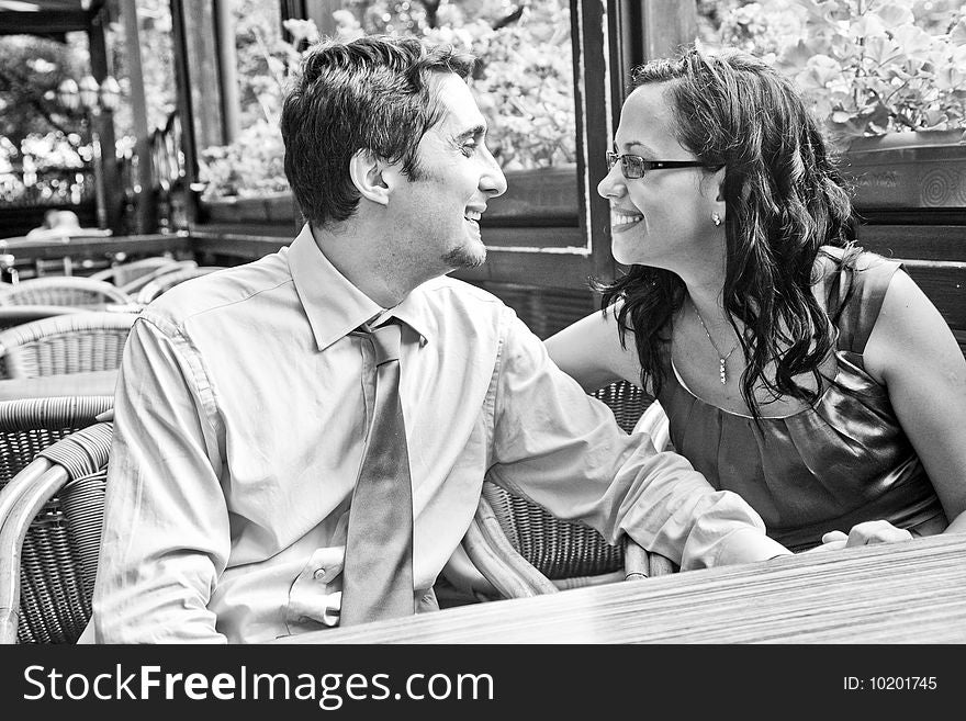 Happy carefree couple laughing at restaurant table. Happy carefree couple laughing at restaurant table